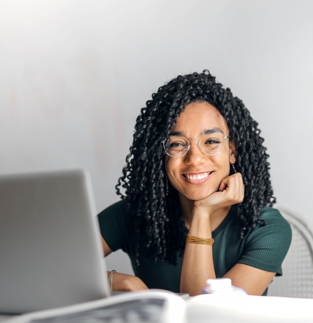 Woman smiling at the camera won laptop